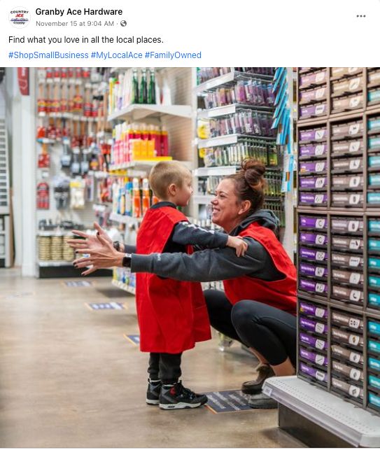 social media post by granby country ace hardware store with store associate helping a child with red vest