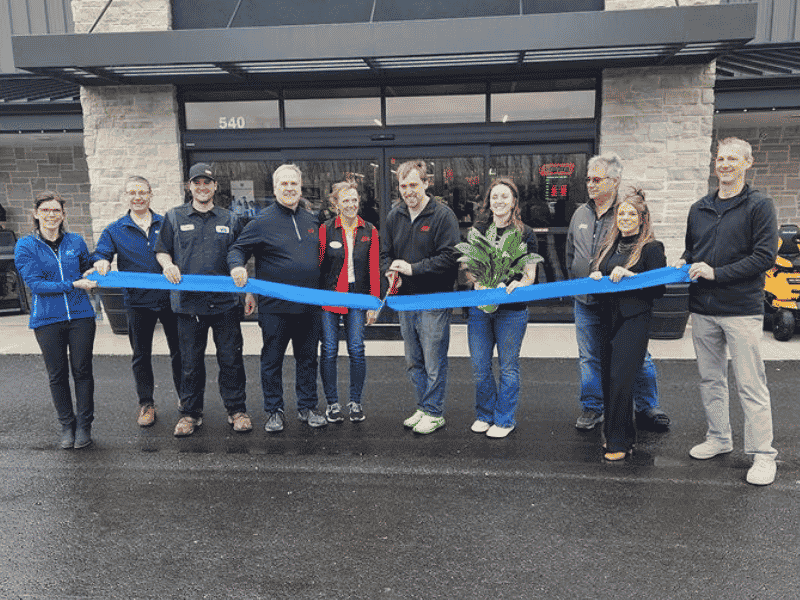 Kimps Ace team cutting a ribbon at a store opening