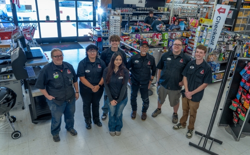 Team members of timberline ace group photo in store